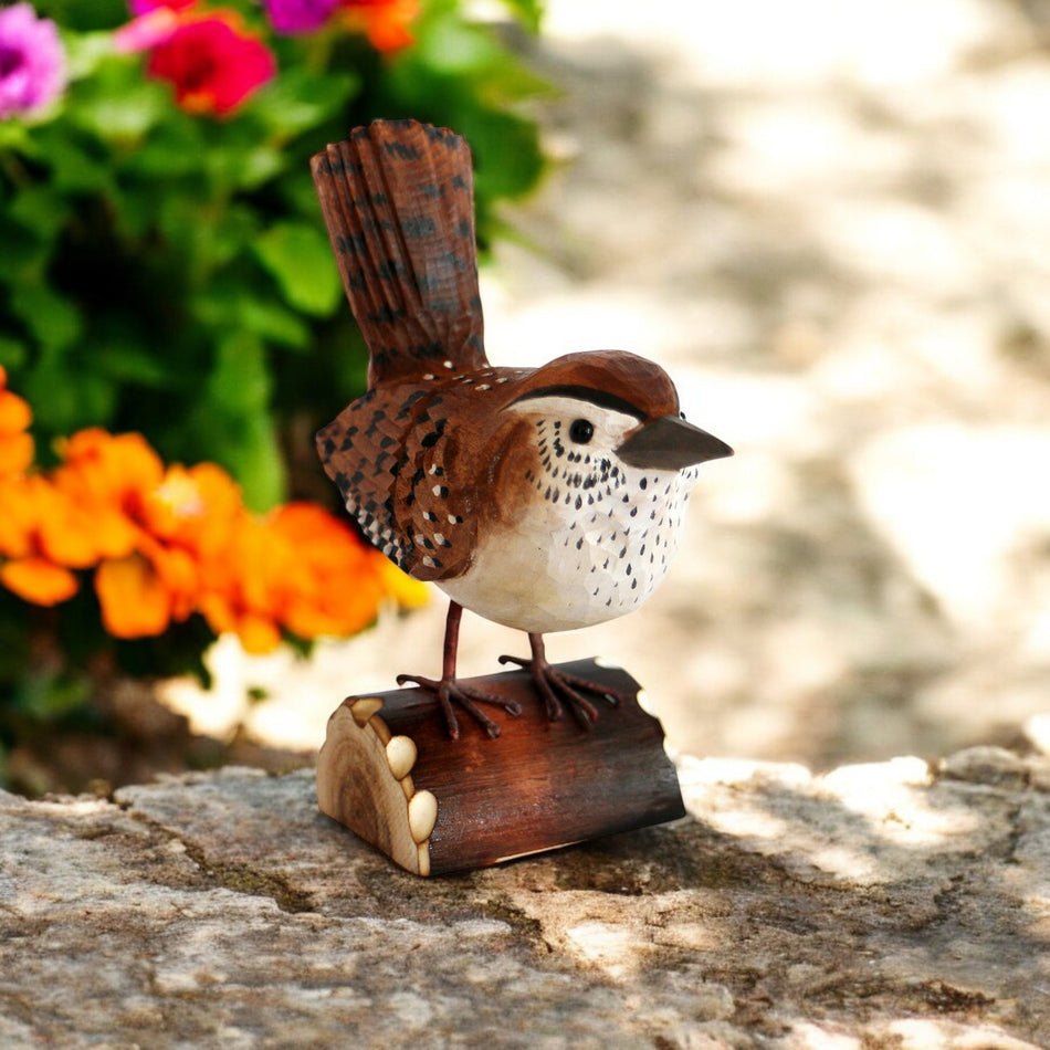 a small bird sitting on top of a piece of wood